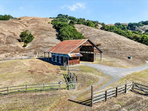 an aerial view of a house with a yard and lake view