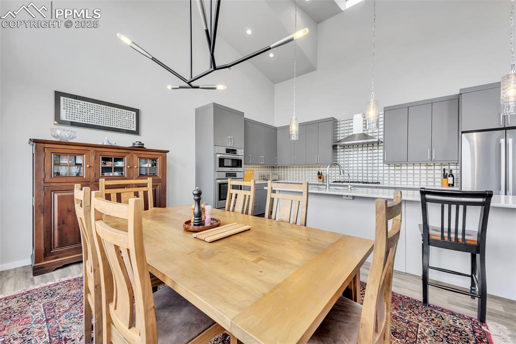 414 Eclipse Drive Colorado Springs, CO 80905 - Photo 13 of 50 Dining area featuring high vaulted ceiling and light wood-style flooring