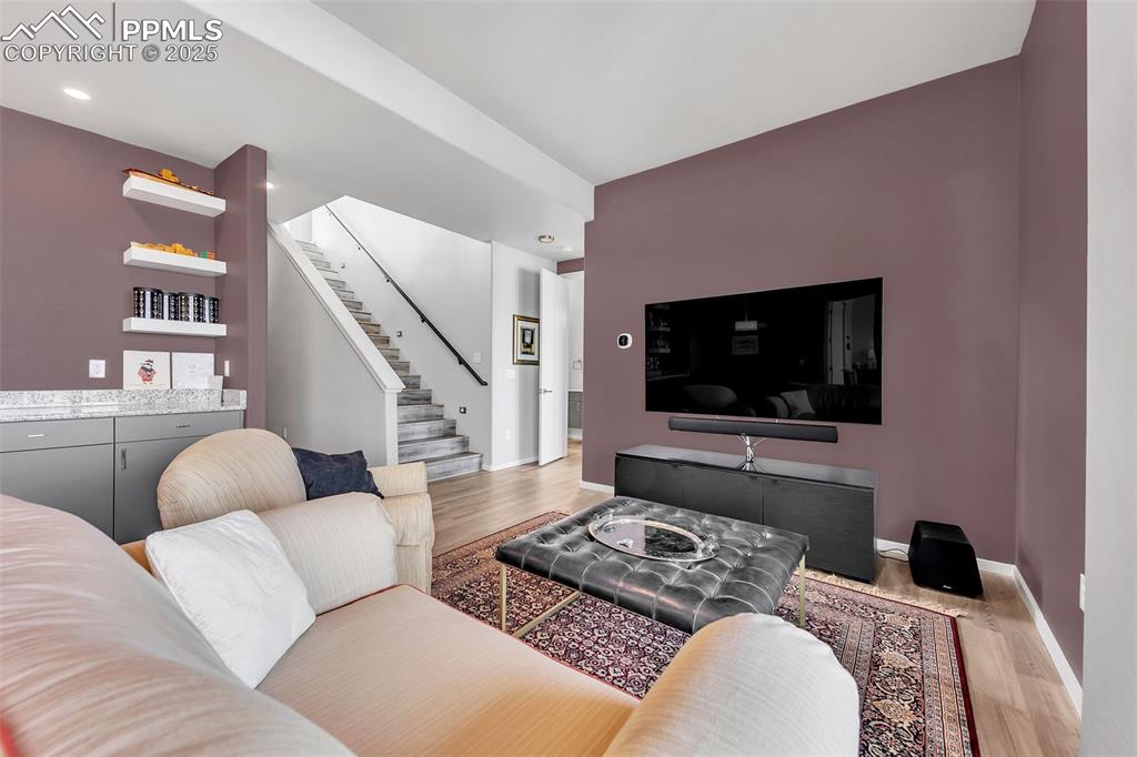 414 Eclipse Drive Colorado Springs, CO 80905 - Photo 29 of 50 Living area featuring baseboards, stairs, wood finished floors, and recessed lighting