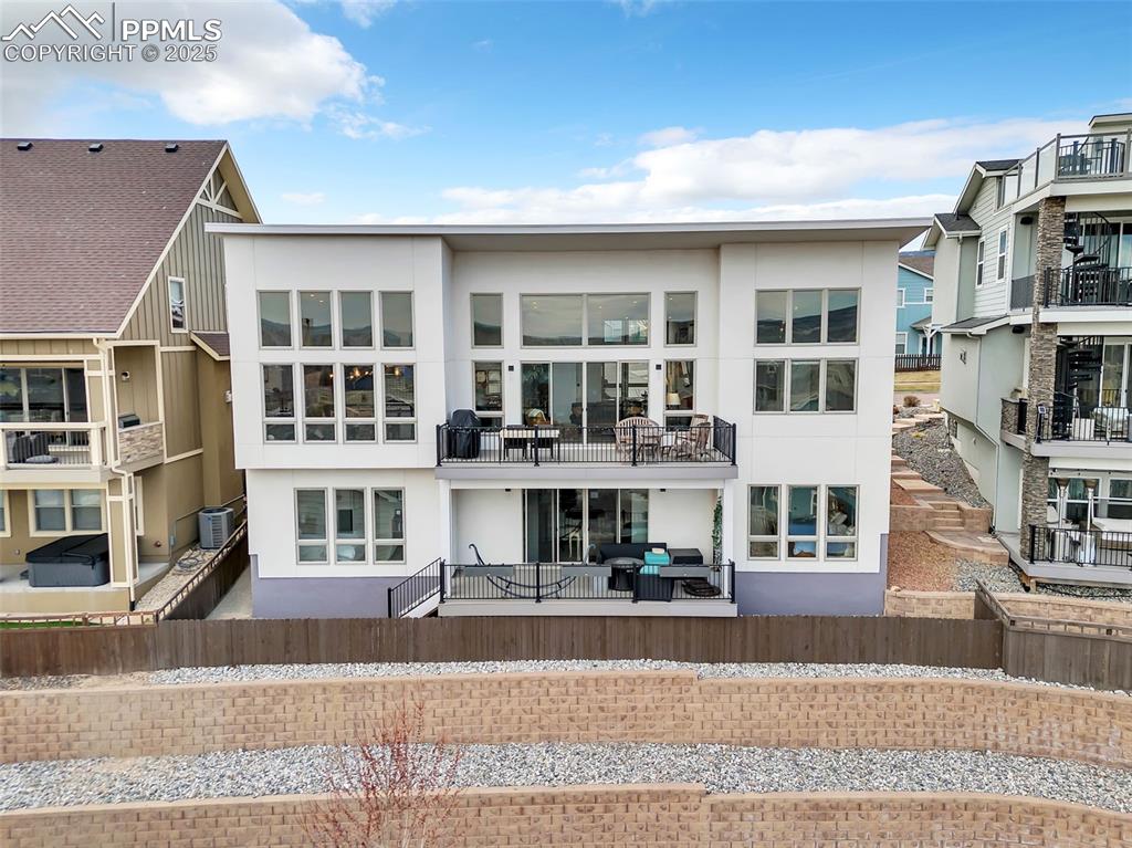 414 Eclipse Drive Colorado Springs, CO 80905 - Photo 45 of 50 Rear view of property with cooling unit, a balcony, and stucco siding