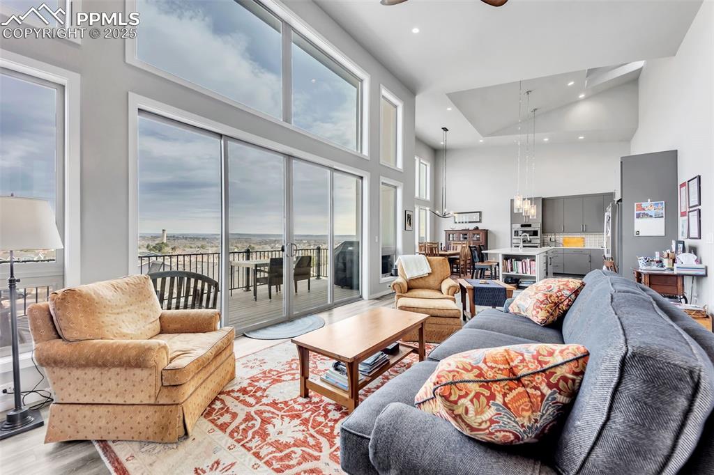 414 Eclipse Drive Colorado Springs, CO 80905 - Photo 5 of 50 Living area featuring ceiling fan with notable chandelier, high vaulted ceiling, light wood-style floors, and recessed lighting