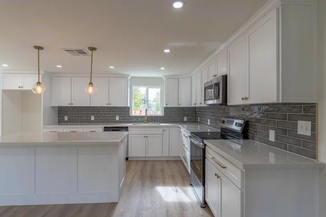 a kitchen with a sink stove and cabinets