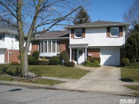 3463 Manchester Road Wantagh, NY 11793 - Photo 1 of 1 a front view of a house with a yard