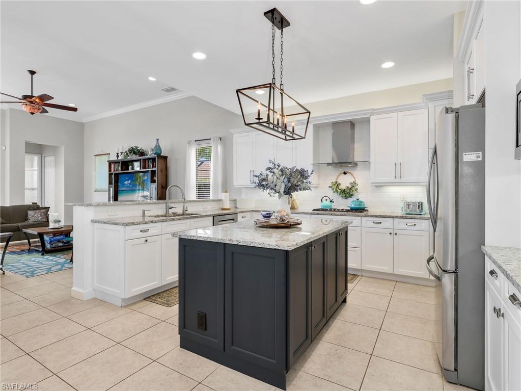 2756 Crystal Way Naples, FL 34119 - Photo 19 of 50 a kitchen with a sink and cabinets
