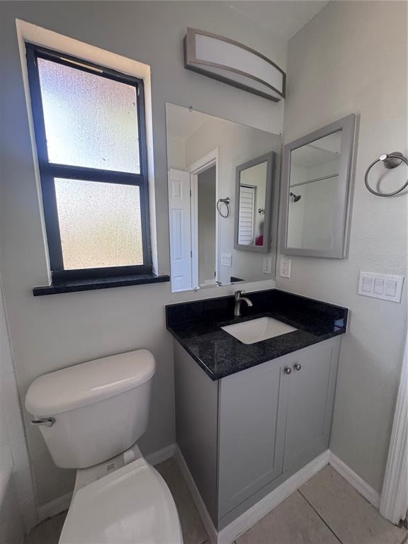 1755 Highland Road Osprey, FL 34229 - Photo 17 of 31 a bathroom with a granite countertop sink toilet and mirror