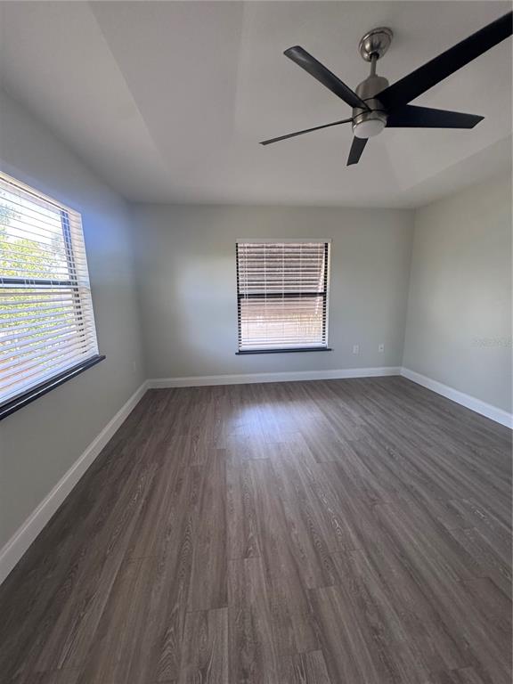 1755 Highland Road Osprey, FL 34229 - Photo 18 of 31 a view of an empty room with wooden floor and a window