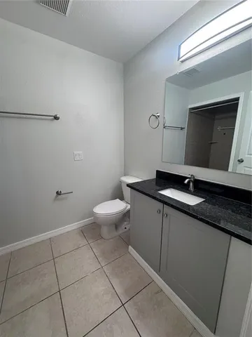 a bathroom with a sink a toilet and mirror