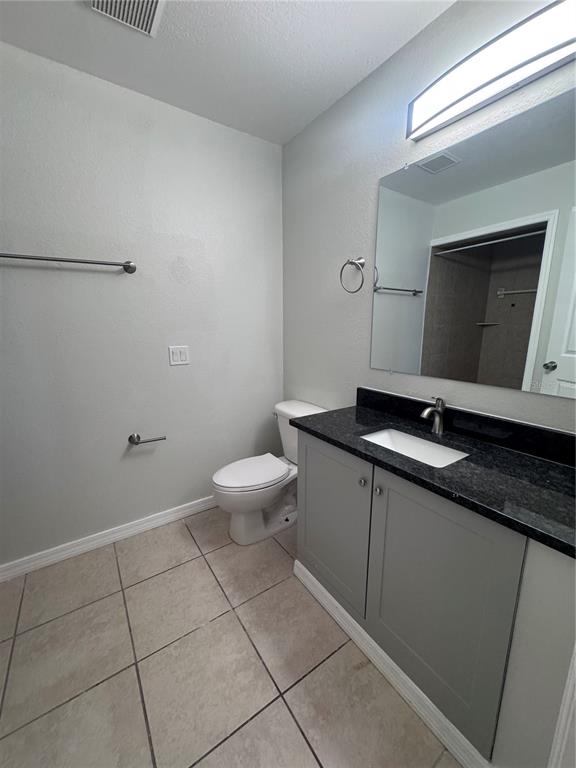 1755 Highland Road Osprey, FL 34229 - Photo 19 of 31 a bathroom with a sink a toilet and mirror