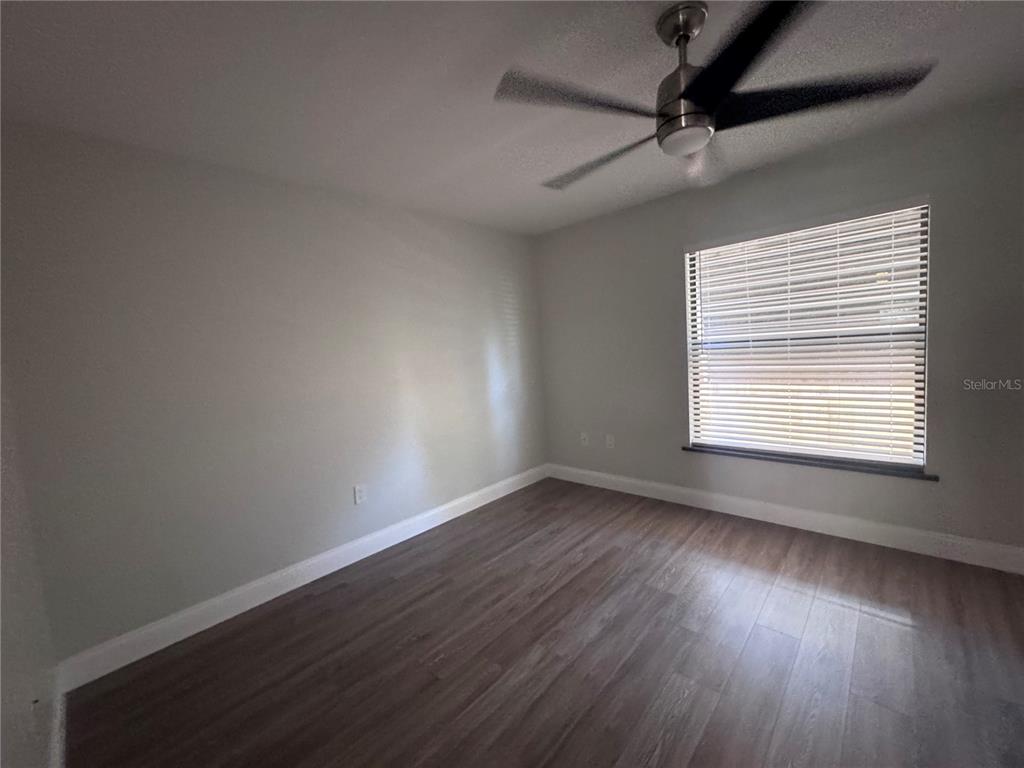 1755 Highland Road Osprey, FL 34229 - Photo 22 of 31 a view of an empty room with wooden floor and a window