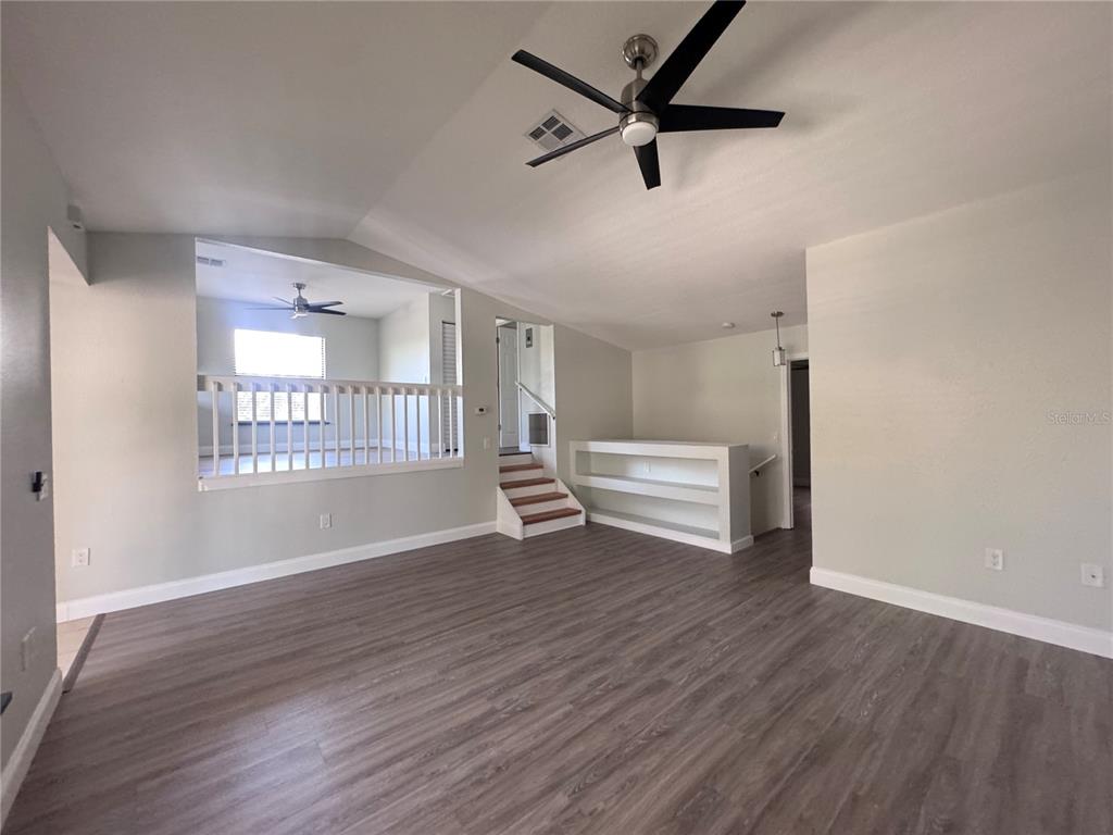 1755 Highland Road Osprey, FL 34229 - Photo 3 of 31 an empty room with wooden floor and windows
