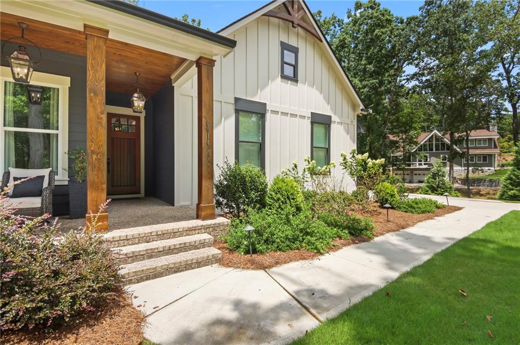 6014 Warpath Road Flowery Branch, GA 30542 - Photo 1 of 36 a front view of a house with a yard