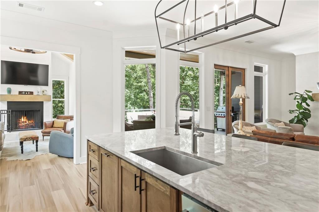 6014 Warpath Road Flowery Branch, GA 30542 - Photo 14 of 36 a kitchen with a sink a counter space and living room