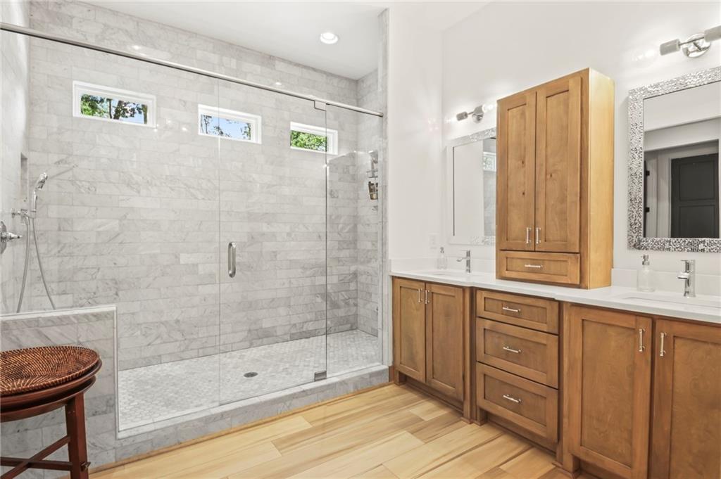 6014 Warpath Road Flowery Branch, GA 30542 - Photo 17 of 36 a bathroom with a shower sink and mirror
