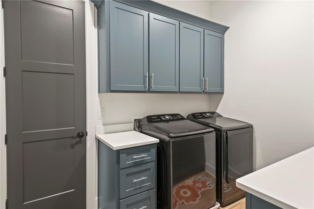 6014 Warpath Road Flowery Branch, GA 30542 - Photo 18 of 36 a utility room with dryer and washer