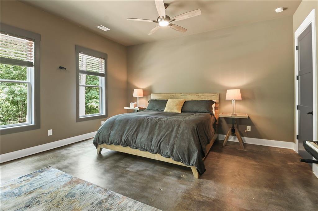 6014 Warpath Road Flowery Branch, GA 30542 - Photo 19 of 36 a bedroom with a bed and window