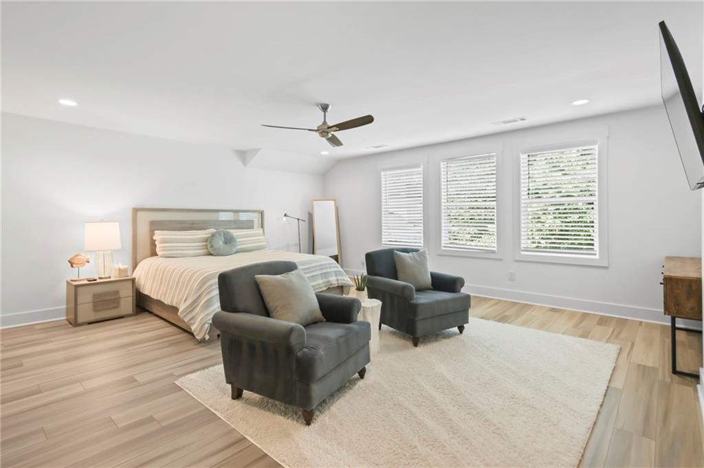 6014 Warpath Road Flowery Branch, GA 30542 - Photo 21 of 36 a bedroom with a large bed and a couch