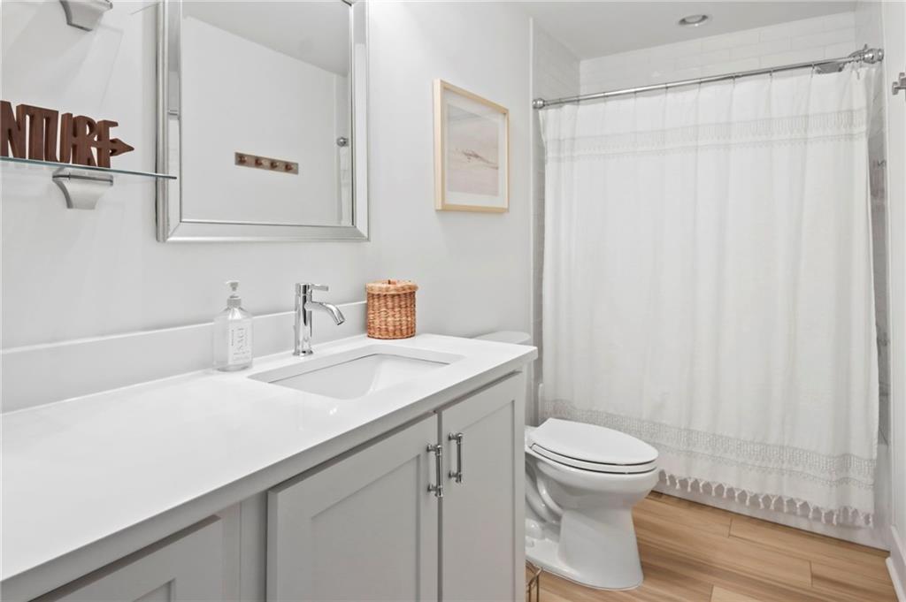 6014 Warpath Road Flowery Branch, GA 30542 - Photo 22 of 36 a bathroom with a sink a toilet and shower