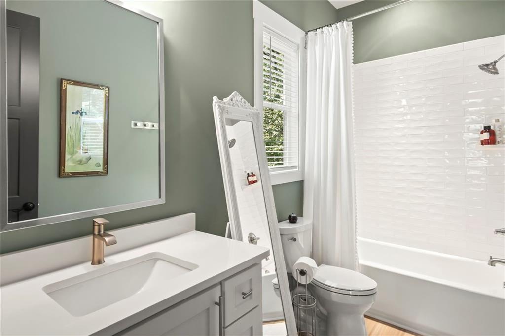 6014 Warpath Road Flowery Branch, GA 30542 - Photo 24 of 36 a bathroom with a sink toilet vanity and tub