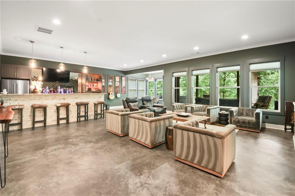 6014 Warpath Road Flowery Branch, GA 30542 - Photo 25 of 36 a living room with lots of furniture and a large window