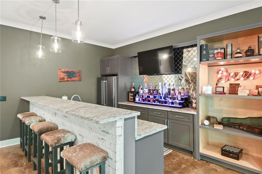 6014 Warpath Road Flowery Branch, GA 30542 - Photo 27 of 36 a kitchen with stainless steel appliances kitchen island granite countertop a stove a sink and a refrigerator