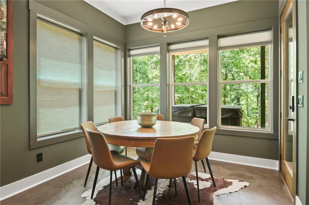 6014 Warpath Road Flowery Branch, GA 30542 - Photo 28 of 36 a dining room with furniture a large window and a chandelier