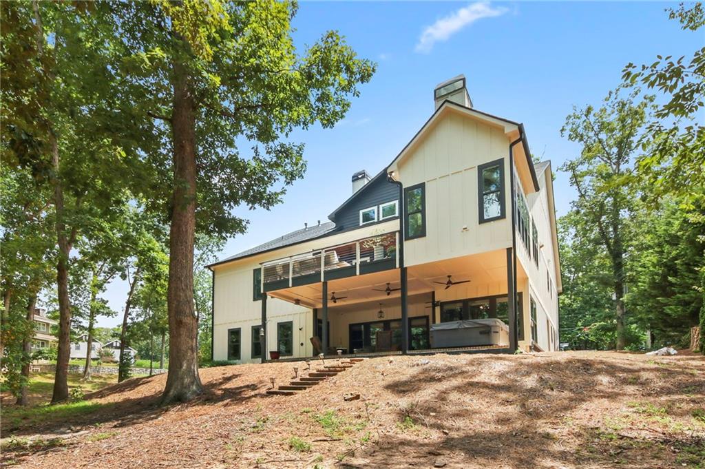 6014 Warpath Road Flowery Branch, GA 30542 - Photo 34 of 36 a front view of a house with a yard covered with snow and trees