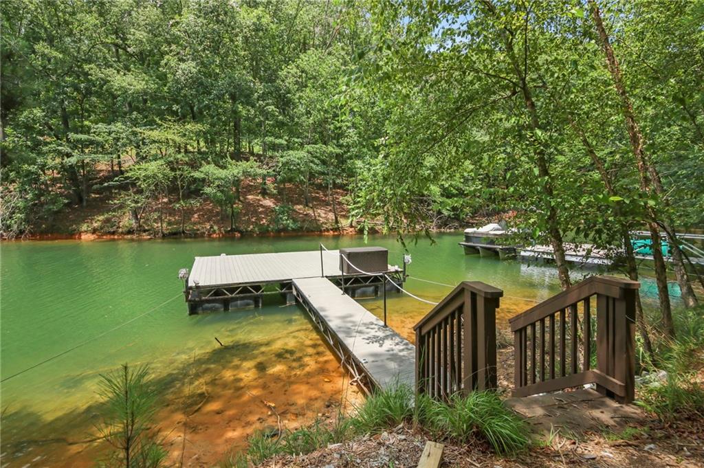 6014 Warpath Road Flowery Branch, GA 30542 - Photo 35 of 36 a view of a wooden deck and lake