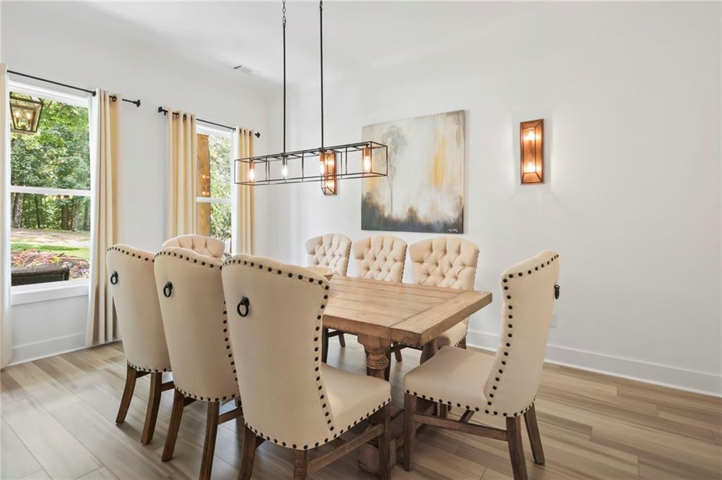 6014 Warpath Road Flowery Branch, GA 30542 - Photo 5 of 36 a dining room with furniture and window