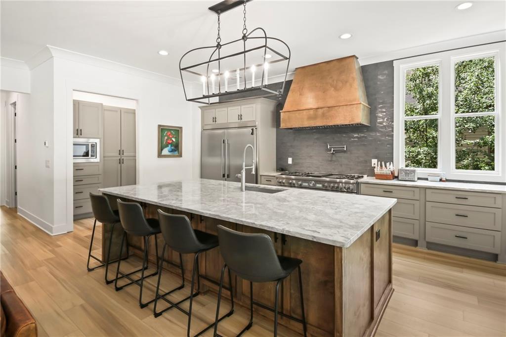 6014 Warpath Road Flowery Branch, GA 30542 - Photo 10 of 36 a kitchen with a table chairs sink and wooden floor