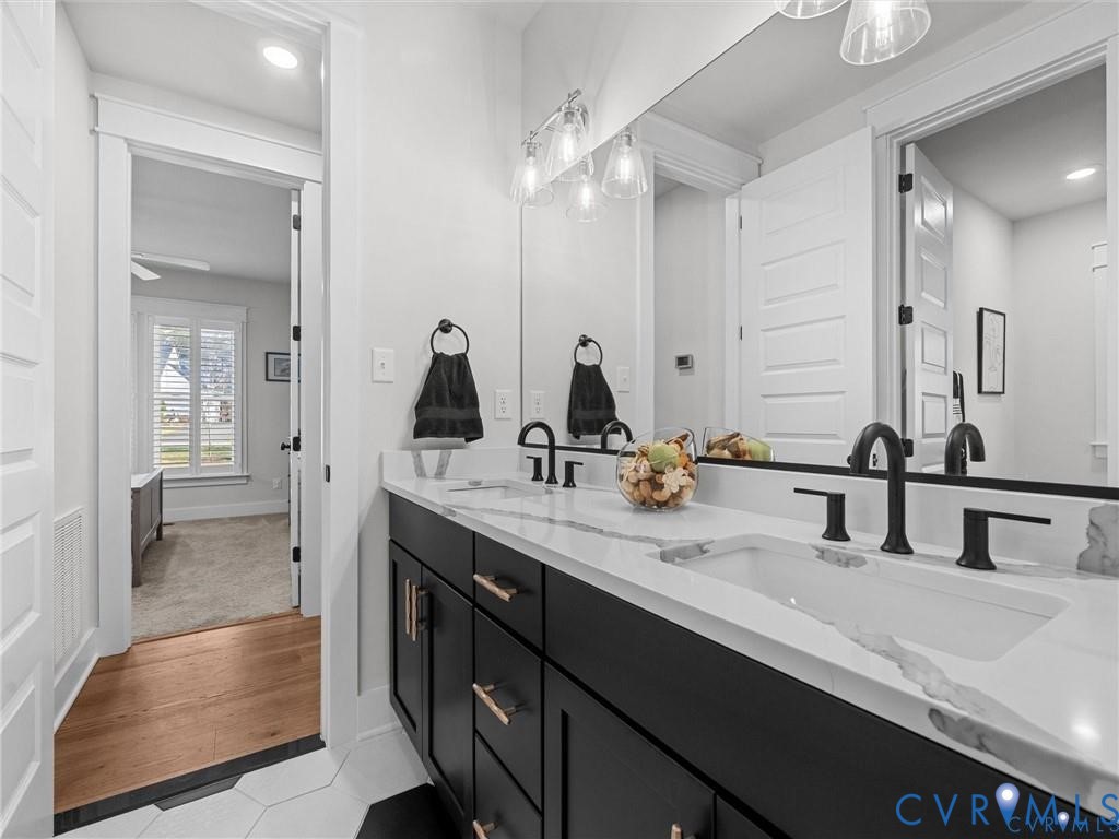 13406 Drake Mallard Court Chesterfield, VA 23838 - Photo 28 of 58 a bathroom with double vanity sinks and a mirror