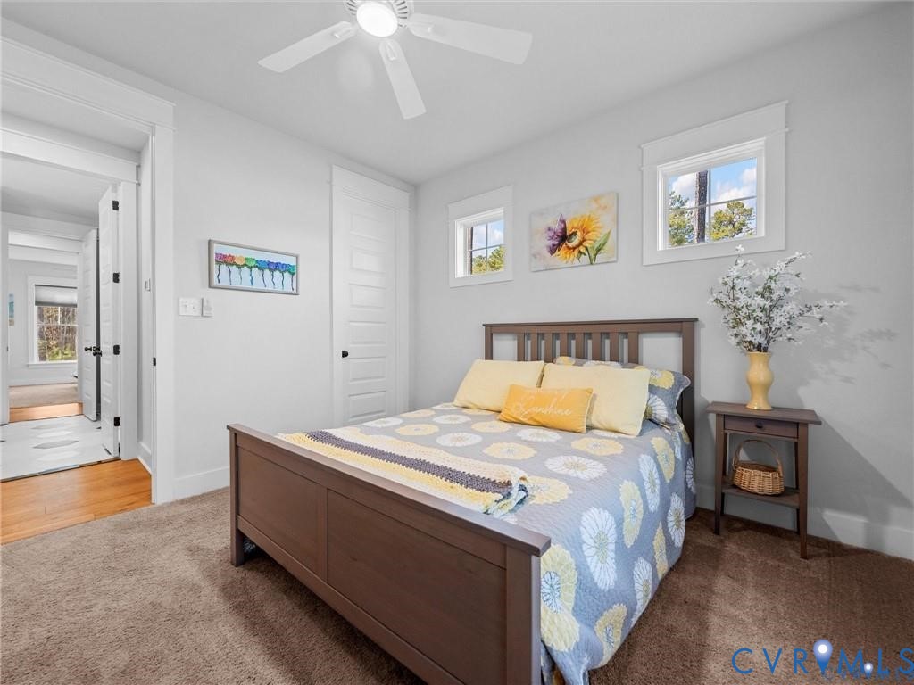13406 Drake Mallard Court Chesterfield, VA 23838 - Photo 32 of 58 a bedroom with a bed and a chandelier