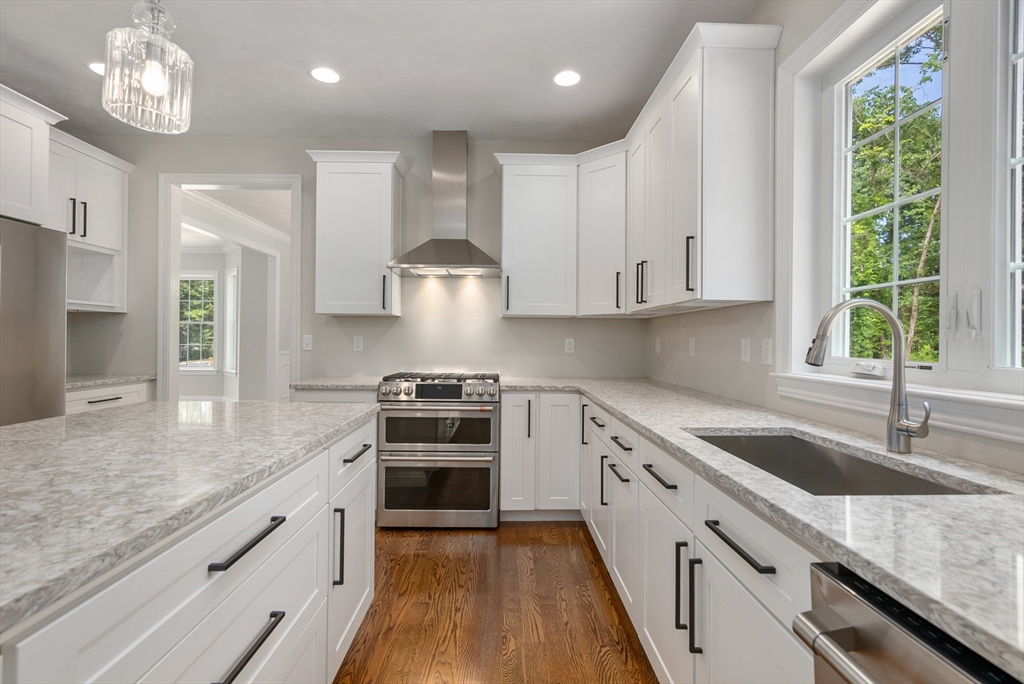 Lot 1 Quinn Road Marlborough, MA 01752 - Photo 11 of 26 a kitchen with stainless steel appliances granite countertop a sink stove a refrigerator and a white cabinets with wooden floor