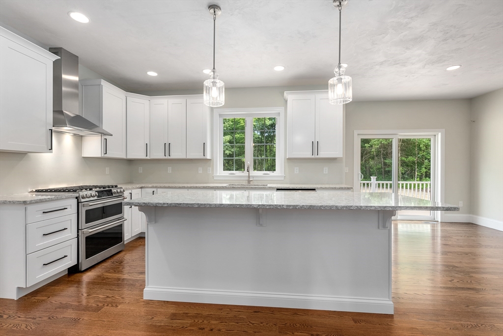 Lot 1 Quinn Road Marlborough, MA 01752 - Photo 12 of 26 a kitchen with stainless steel appliances granite countertop a stove a sink and a wooden floors