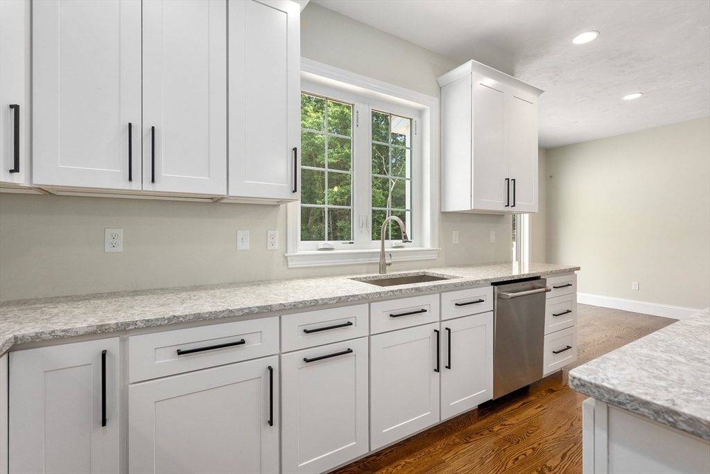 Lot 1 Quinn Road Marlborough, MA 01752 - Photo 13 of 26 a kitchen with granite countertop white cabinets and a sink