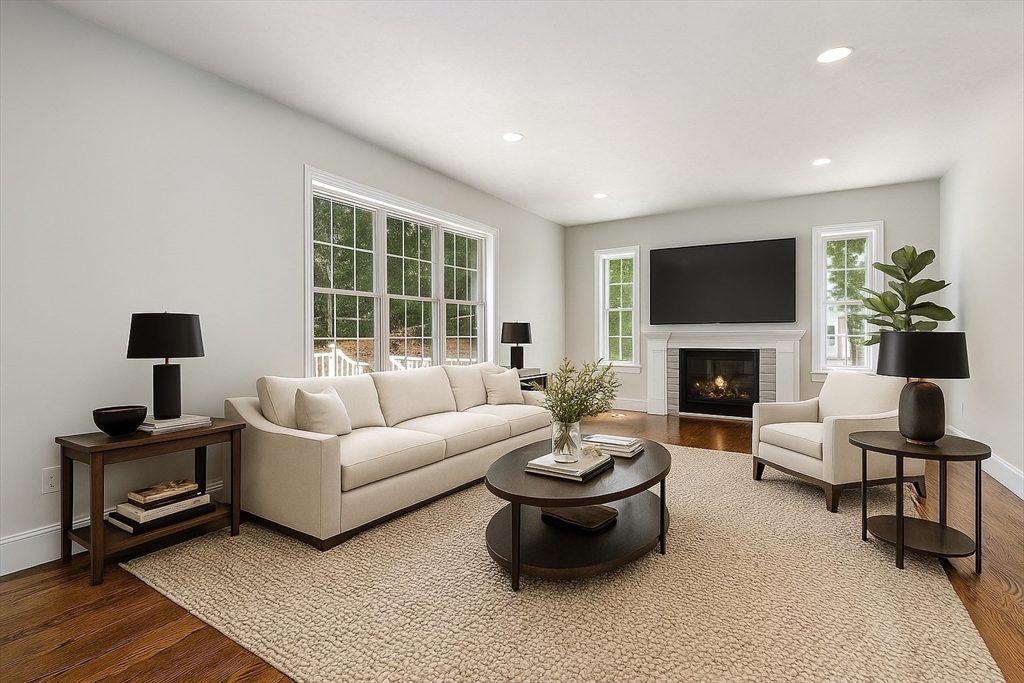 Lot 1 Quinn Road Marlborough, MA 01752 - Photo 15 of 26 a living room with furniture a fireplace and a flat screen tv