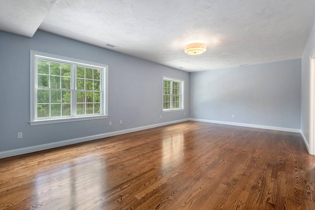 Lot 1 Quinn Road Marlborough, MA 01752 - Photo 17 of 26 an empty room with wooden floor and windows