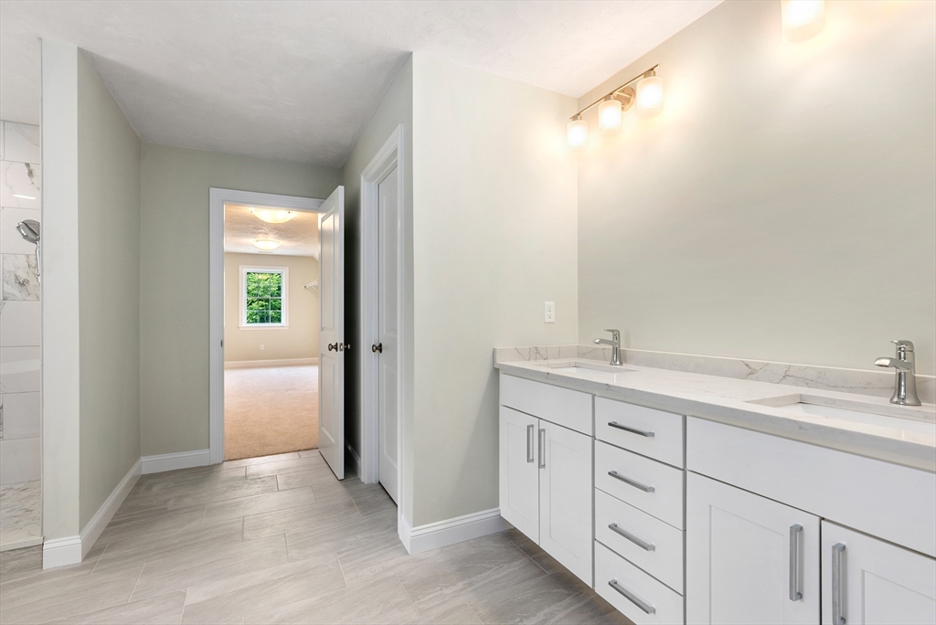 Lot 1 Quinn Road Marlborough, MA 01752 - Photo 18 of 26 a spacious bathroom with a double vanity sink a mirror and a shower