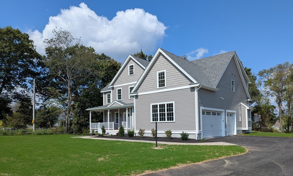 Lot 1 Quinn Road Marlborough, MA 01752 - Photo 2 of 26 a front view of a house with a yard and trees