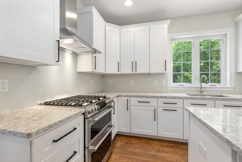 Lot 1 Quinn Road Marlborough, MA 01752 - Photo 7 of 26 a kitchen with granite countertop a sink stove and cabinets