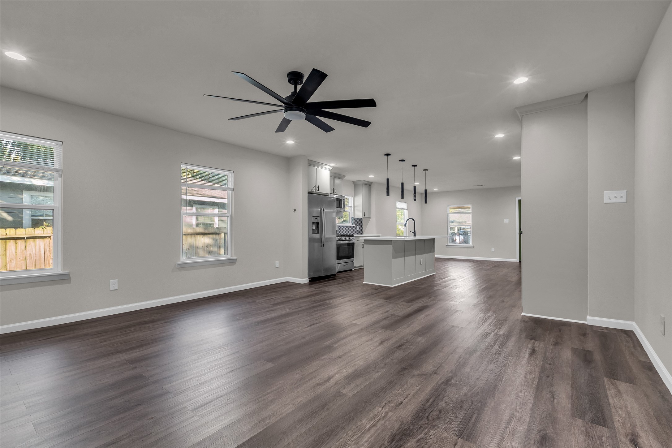 116 Gans Street Houston, TX 77029 - Photo 11 of 25 a view of a kitchen with a dishwasher a kitchen island hardwood floor and a window