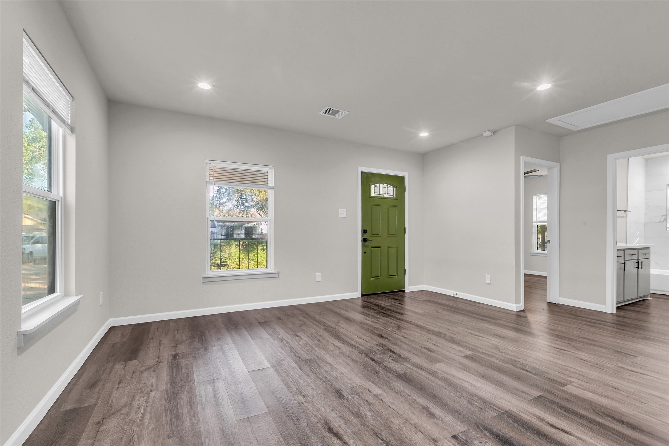 116 Gans Street Houston, TX 77029 - Photo 15 of 25 a view of an empty room with wooden floor and a window