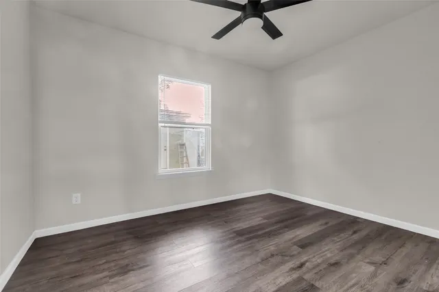 wooden floor in an empty room with a window