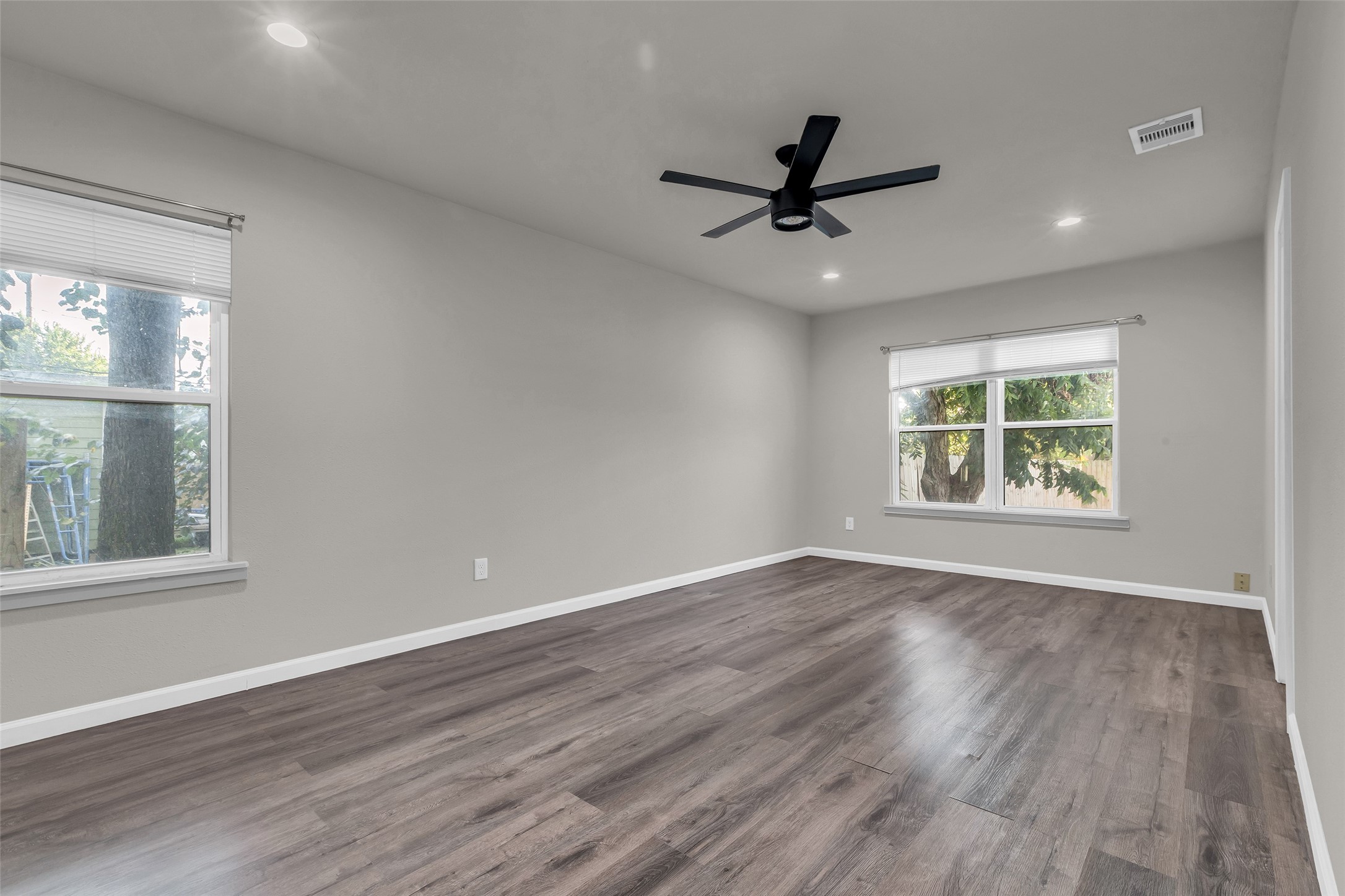116 Gans Street Houston, TX 77029 - Photo 20 of 25 a view of an empty room with wooden floor and a window