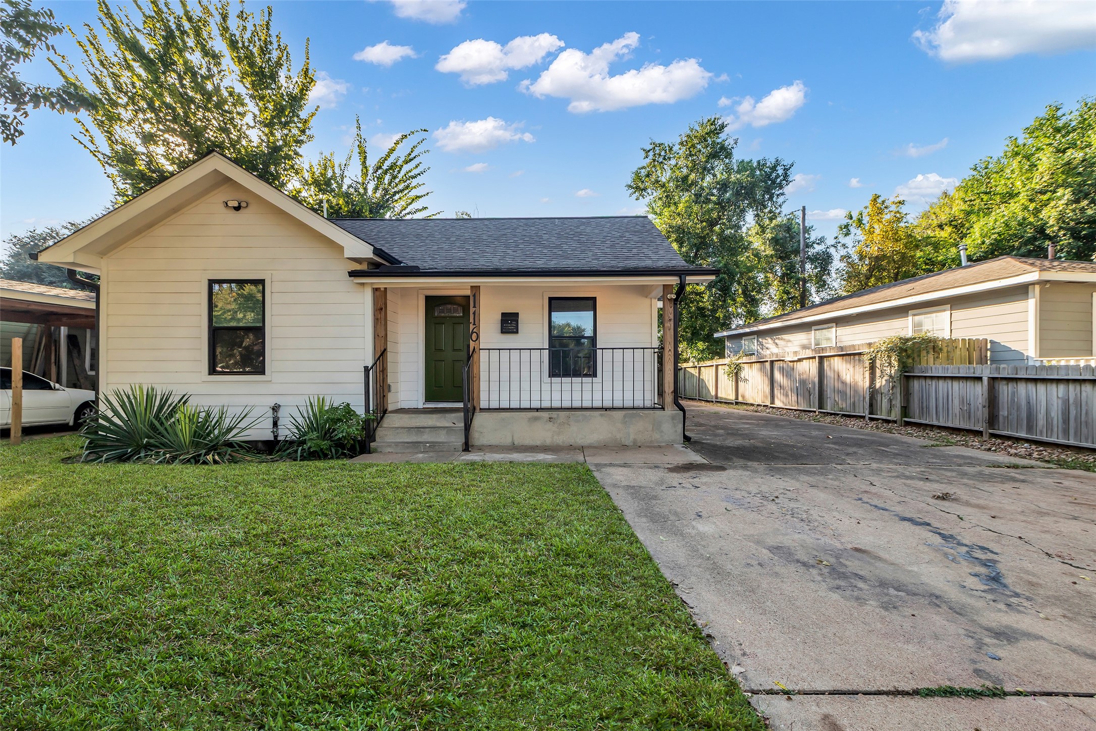 116 Gans Street Houston, TX 77029 - Photo 2 of 25 a front view of a house with a yard and garage