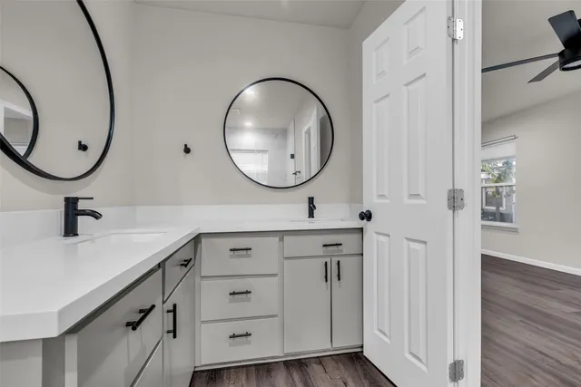 a bathroom with a double vanity sink and a mirror