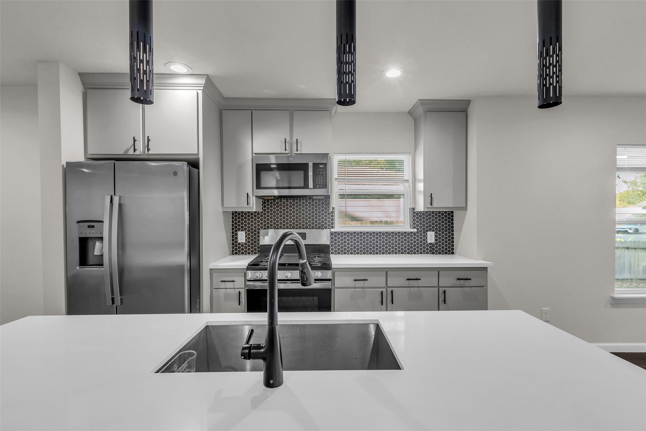 116 Gans Street Houston, TX 77029 - Photo 24 of 25 a kitchen with stainless steel appliances kitchen island a refrigerator sink and cabinets