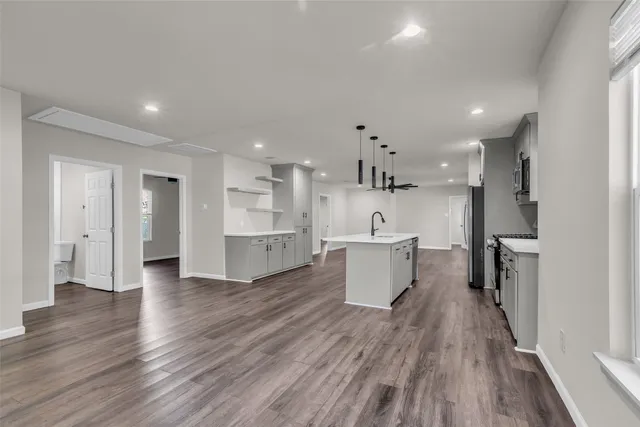 a large kitchen with a lot of counter space and a refrigerator