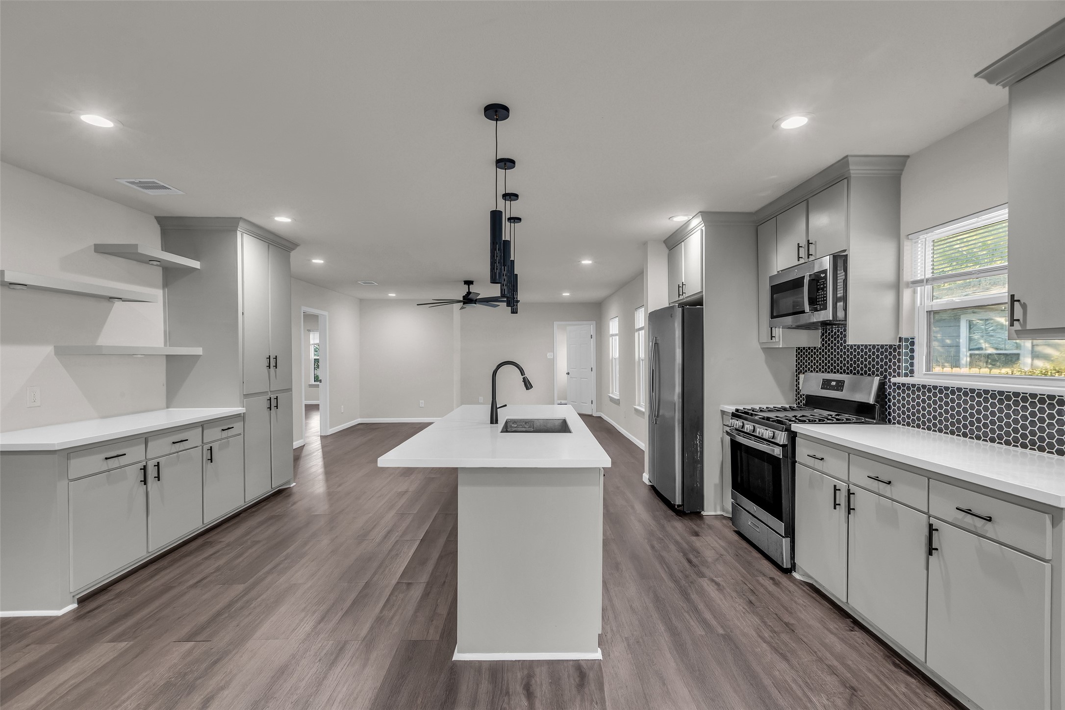116 Gans Street Houston, TX 77029 - Photo 6 of 25 a kitchen with a sink stove cabinets and refrigerator