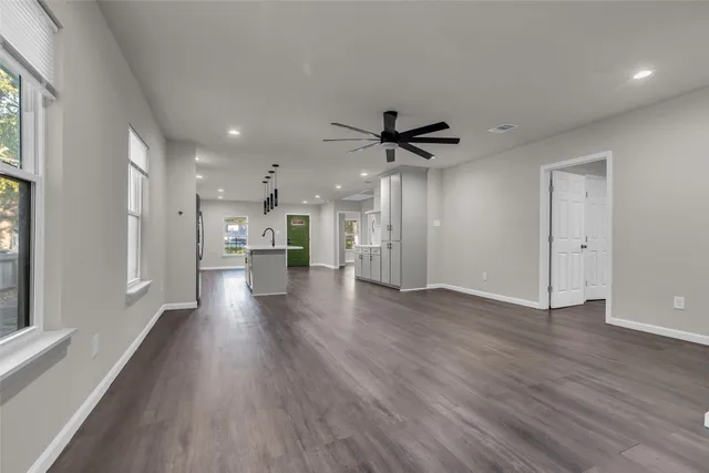 a view of a kitchen with a sink and a refrigerator