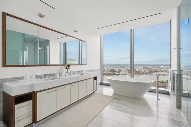 a bathroom with a double vanity sink and a large mirror